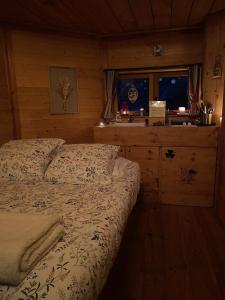 a bedroom with a bed and a window at Les Cabanes de Maya in Caille