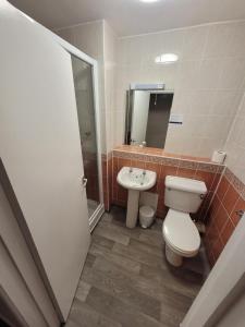 a bathroom with a toilet and a sink at Cavendish Hotel in Exmouth