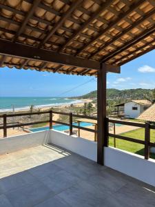 a view of the beach from the balcony of a house at Pousada Villa Sagi in Baía Formosa