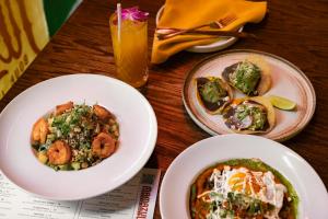 a table with three plates of food and a drink at Sonder Flatiron in New York