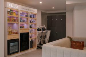 a living room with a couch and a shelf with food at Sonder Flatiron in New York