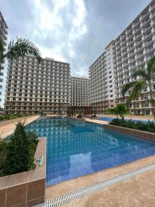 Lapu Lapu CityにあるCozy Pool and Seaview Condo in Cebu with Balcony near Mactan Airportの大きなスイミングプール付きの大きなアパートメントです。
