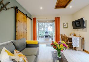 a living room with a couch and a table with flowers at Squirrel in Postling