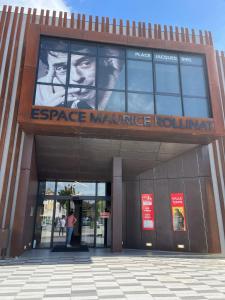 a building with a large sign on the front of it at Studio tropical , vierzon , proche gare , tout confort in Vierzon