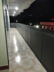 an empty hallway of a building at night at Adarsh Hotel in Port Blair