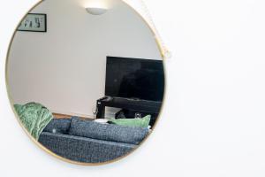 a mirror reflection of a couch in front of a tv at Cosy Apartment near Nottingham City Centre in Nottingham