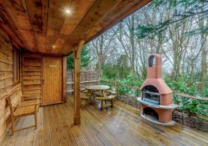 a porch of a cabin with a wood stove at Badger in Postling