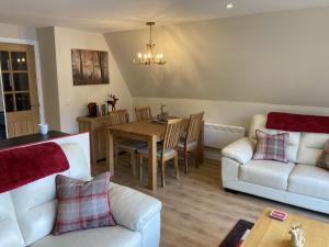 a living room with a table and a couch at Lodge 24 in Spean Bridge