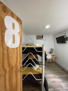 a bedroom with a bunk bed with a closet at Mora Hostel in Mendoza