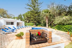 a backyard with a swimming pool and a fire pit at Villa AlGharif by Algarve Vacation in Albufeira
