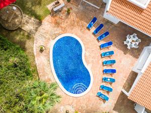 an overhead view of a swimming pool with blue chairs at Villa AlGharif by Algarve Vacation in Albufeira