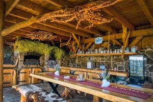 a kitchen with a table and a stone fireplace at VeLa in Malý Slavkov