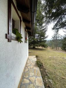 a window on the side of a house with a field at Kućica za odmor '' Idila '' in Mitrovac