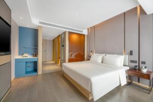 Ένα ή περισσότερα κρεβάτια σε δωμάτιο στο Atour Hotel Xi'an Chanba Exhibition Center Expo Park