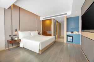 Ένα ή περισσότερα κρεβάτια σε δωμάτιο στο Atour Hotel Xi'an Chanba Exhibition Center Expo Park