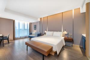 a hotel room with a bed and a chair at Atour Hotel Xi'an Chanba Exhibition Center Expo Park in Xi'an
