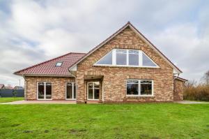 a house with a large green lawn at Haus mit Seeblick in Nenndorf