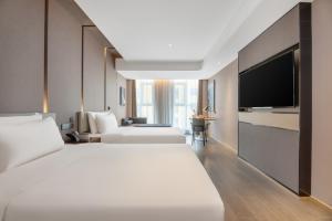 Ένα ή περισσότερα κρεβάτια σε δωμάτιο στο Atour Hotel Xi'an Chanba Exhibition Center Expo Park
