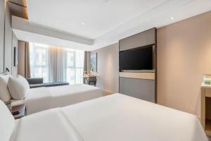 Ένα ή περισσότερα κρεβάτια σε δωμάτιο στο Atour Hotel Xi'an Chanba Exhibition Center Expo Park