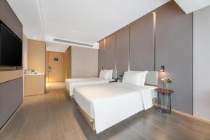 Ένα ή περισσότερα κρεβάτια σε δωμάτιο στο Atour Hotel Xi'an Chanba Exhibition Center Expo Park