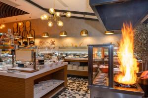 a restaurant with a fire display in front of a buffet at Ramada Encore by Wyndham Istanbul Sisli in Istanbul
