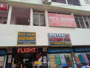 a bunch of signs on the side of a building at Griham Inn in Guwahati