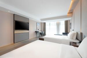 Ένα ή περισσότερα κρεβάτια σε δωμάτιο στο Atour Hotel Xi'an Chanba Exhibition Center Expo Park