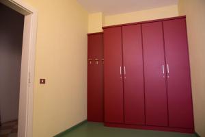 a row of red lockers in a room at Hotel Villa Flora in Roncegno