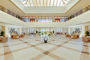 a large lobby with couches and a large ceiling at Sunrise Alma Bay Resort in Hurghada