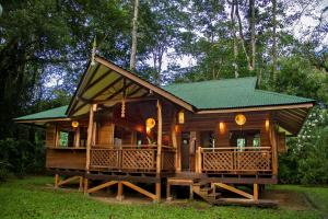 a cabin in the woods with a green roof at Finca Chica Lodge & Villas in Puerto Viejo +117 photos