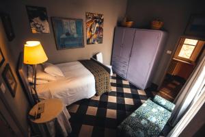 a bedroom with a bed with a lamp and a dresser at Palazzo Romani Adami in Fermo