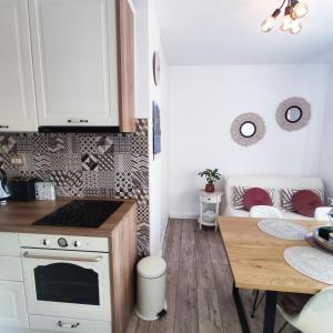 a small kitchen with a table and a dining room at Lovely home M&R in Split