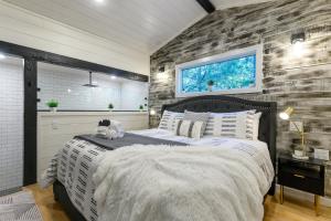 a bedroom with a bed with a stuffed animal on it at Cozy Cabin Perfect for Couples in Broken Bow