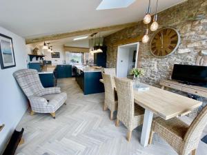 a kitchen and dining room with a table and chairs at Sheepfold Barn in Penruddock