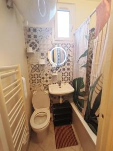 a small bathroom with a toilet and a sink at B Appartement in Malakoff