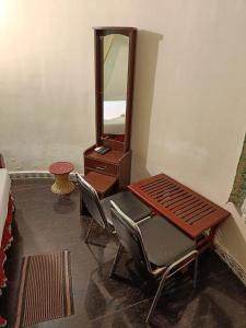 a dressing room with a chair and a mirror at Kottai Veedu Pondicherry in Pondicherry