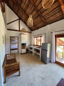 a large kitchen with a refrigerator and a table at Cabana Beach Lodge in Cabo Conguiane