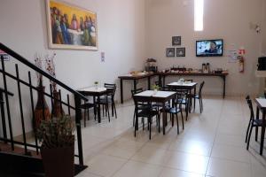 ein Restaurant mit Tischen und Stühlen in einem Zimmer in der Unterkunft Hotel Neblina in Araguaína