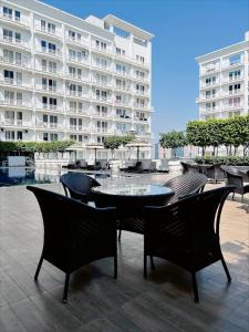 a table and chairs in front of a large building at Country Inn & Suites Lucknow Gomti Nagar in Lucknow