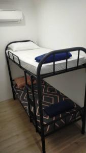 a black bunk bed in a room at Spacious Home @ Kuching City Ctr in Kuching