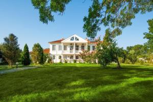 a large white house with a large yard at Casa di Bakalovi in Burgas City