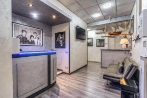 a room with a bar with a couch and a tv at Hotel Planet in Rome