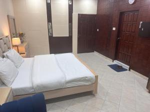 伊斯蘭堡的住宿－Stay Inn Guest House，一间卧室设有一张床和两扇棕色的门