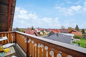 a balcony with a view of a town at Apartments am Hainich - 59m2, 4 Personen, Küche, Netflix, Parken, Hunde Willkommen, Nationalpark in Hörselberg-Hainich