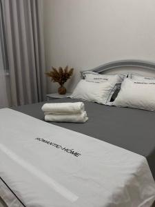 a bed with white sheets and pillows on it at 2х комнатная квартира с кодовым замком in Uralsk +10 photos