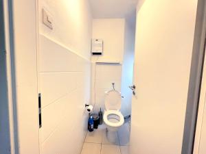 a small bathroom with a toilet in a stall at City Apartments in Hof in Hof +3 photos