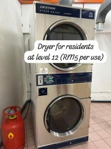 a washer and dryer with the words drier for residents at leveled at Riverview Home @Waterfront KCH in Kuching