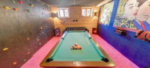 a room with a pool table in a cave at Doug's Mountain Getaway - 'Top Two Floors' in Fulpmes