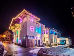 a building with colorful lights on it at night at Doug's Mountain Getaway - 'Top Two Floors' in Fulpmes