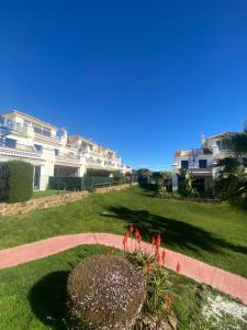 a park with some flowers and some buildings at Costa esuri CASA TRINIDAD in Huelva